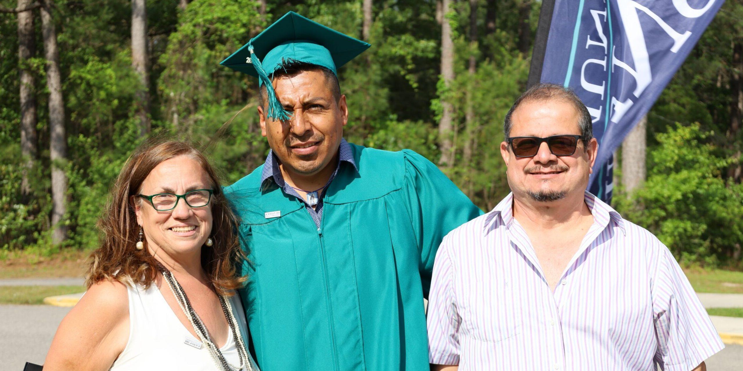 Adult Education graduate with family and instructor